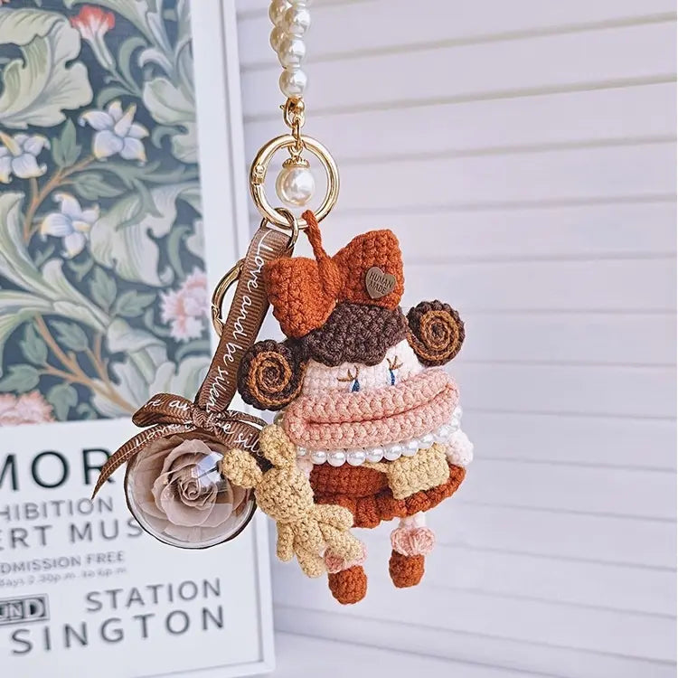 A brown Handcrafted Curly Collection Doll Bag Charm