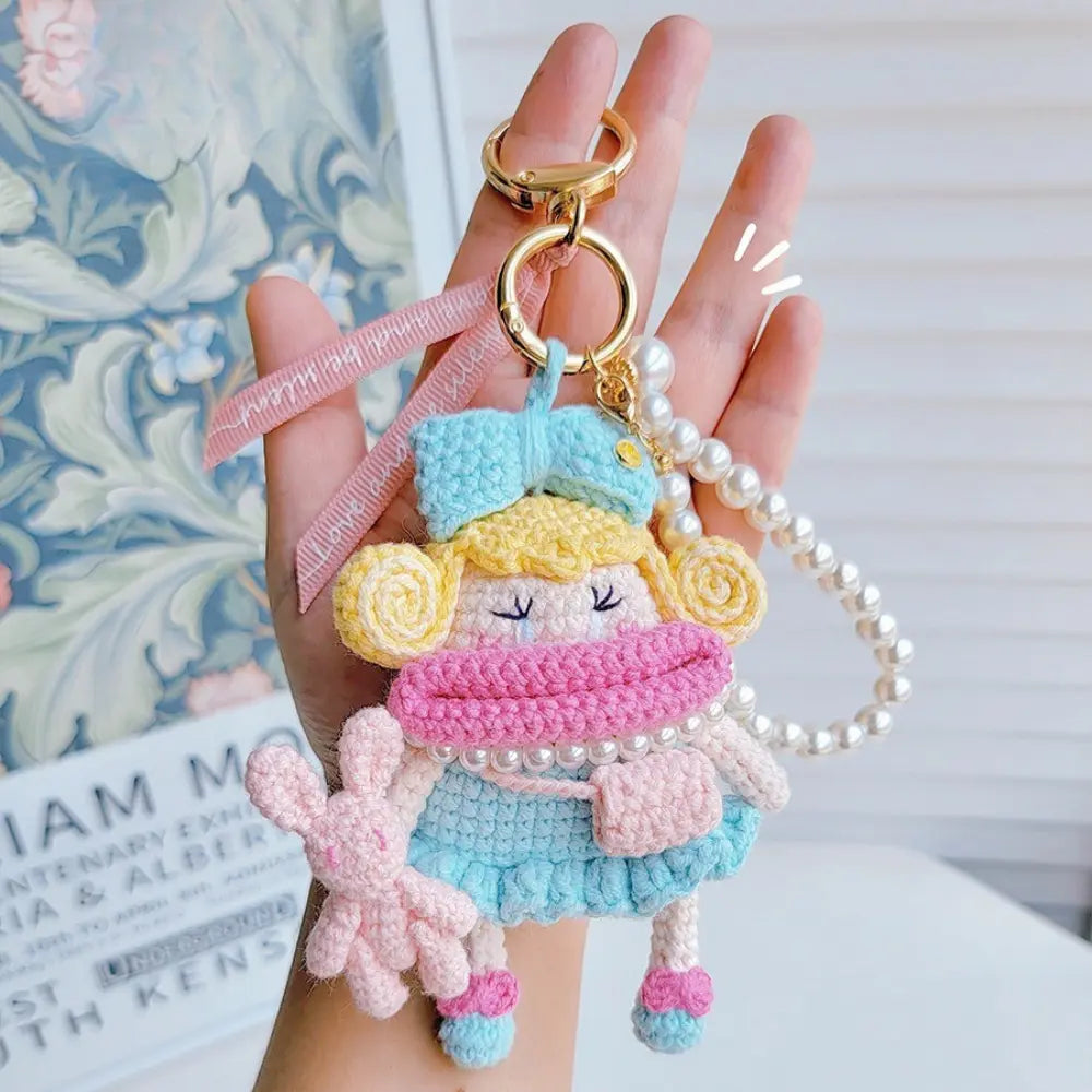 Hand hold a dopamine blue Handcrafted Curly Collection Doll Bag Charm 