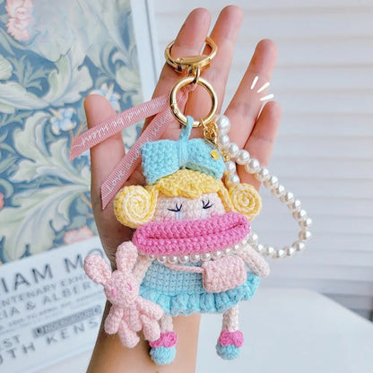 Hand hold a dopamine blue Handcrafted Curly Collection Doll Bag Charm 