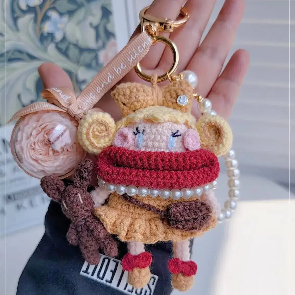 Hand hold an apricot Handcrafted Curly Collection Doll Bag Charm 